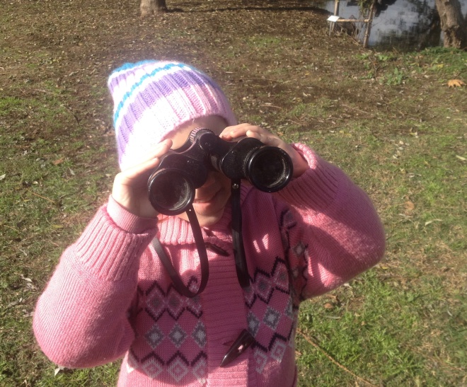 Practicing with her new binoculars.